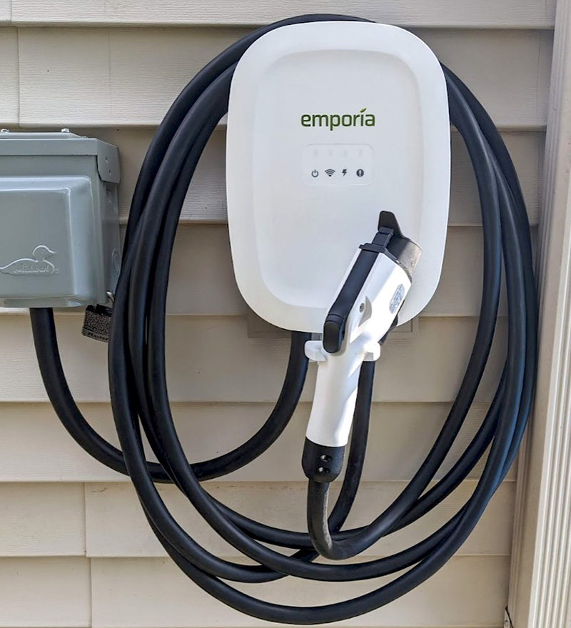 Image of an Emporia EV charger hanging on a wall